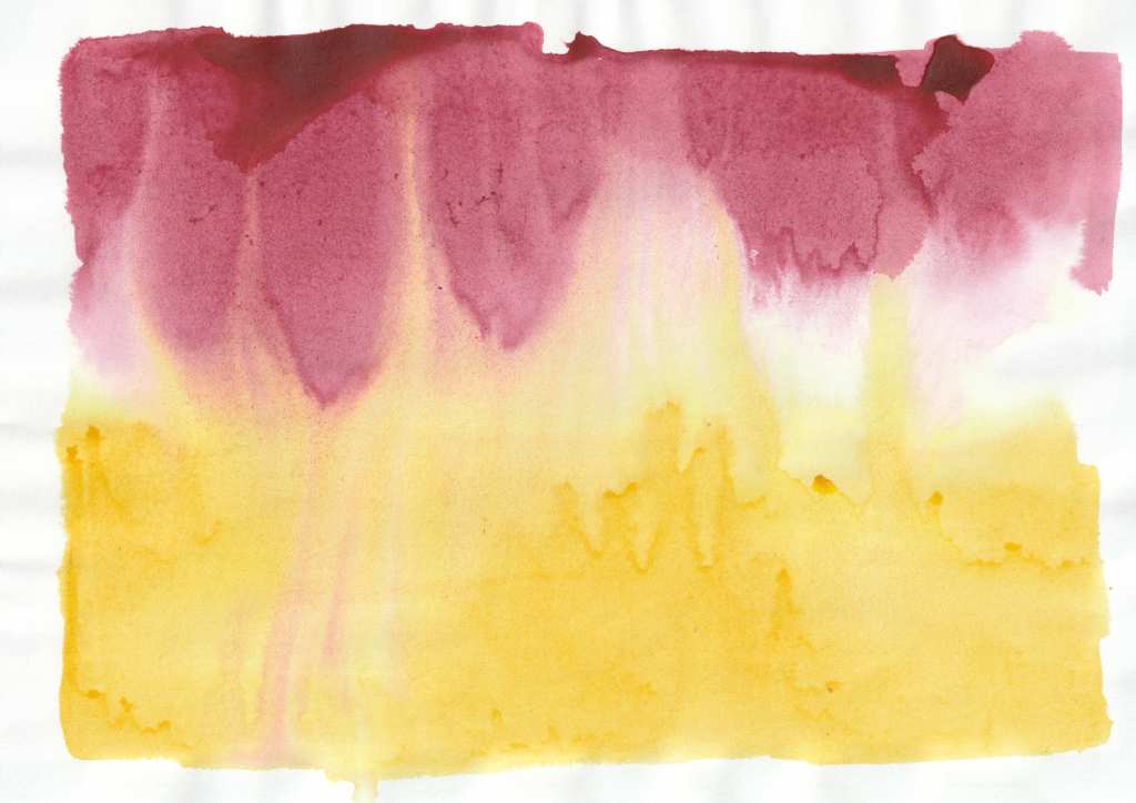 A watercolour painting with two main colour areas. The top section is a deep red with an uneven edge, where the pigment has pooled and spread downwards in soft, vertical streaks. The lower section is a warm yellow, with areas of varying saturation and irregular edges where the colour has diffused into the surrounding space. The two colours blend in the middle, creating subtle transitions and organic, fluid shapes.
